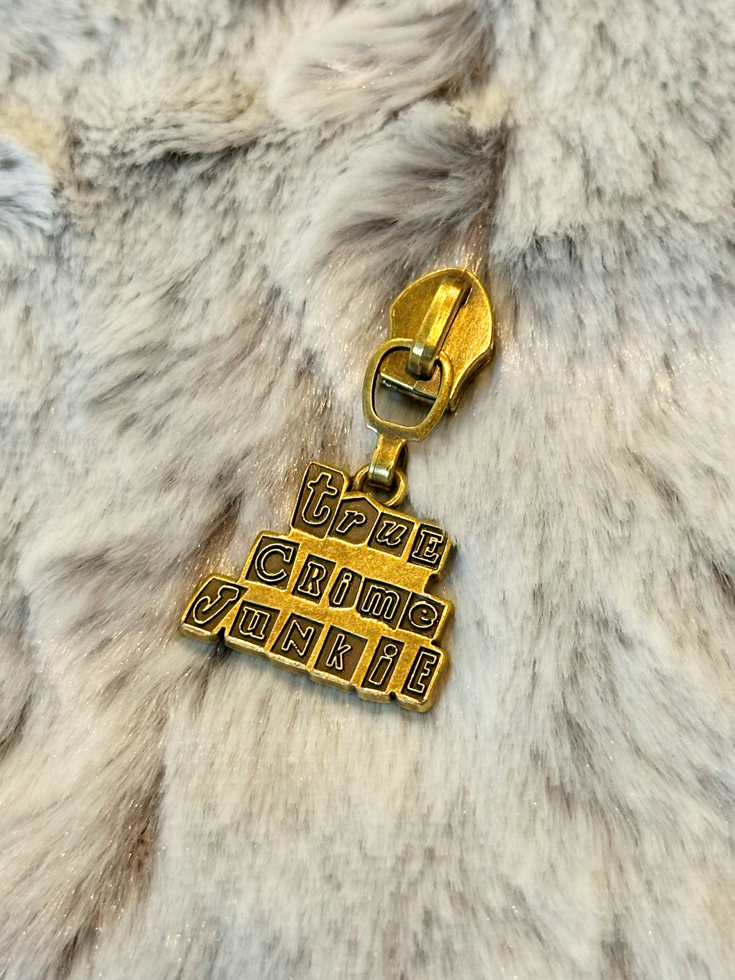 True Crime Junkie Zipper Pull (bronze)